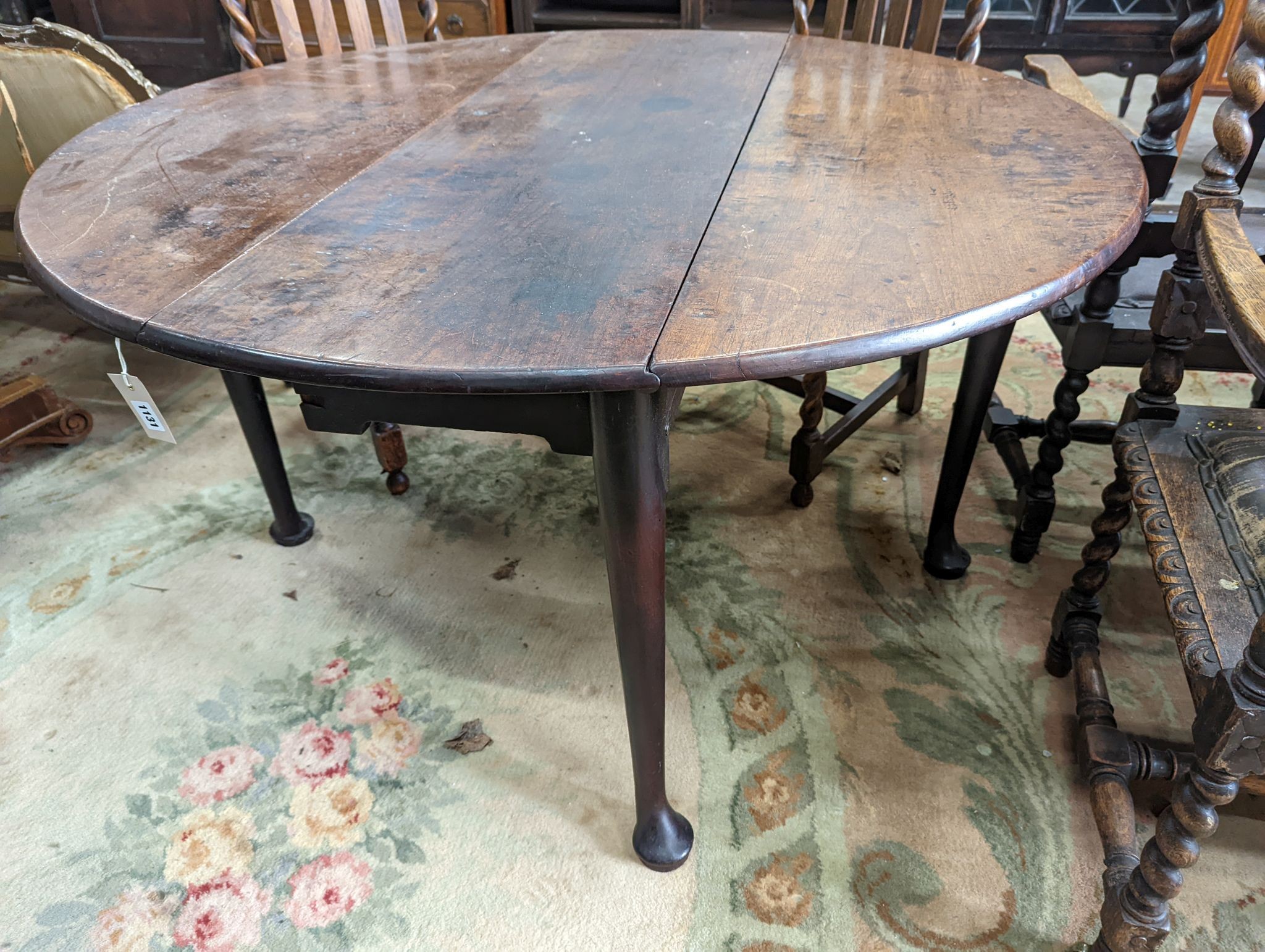 A George III mahogany oval pad foot drop leaf dining table, width 118cm, length 130cm extended, height 71cm